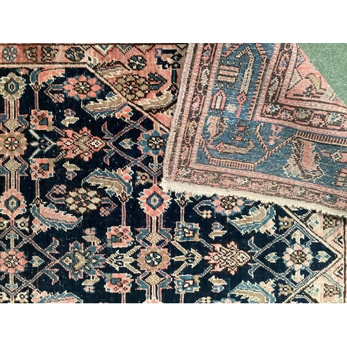 640 - A Persian style rug, with blue border, and central medallion of dark blue ground with pink/cream and... 