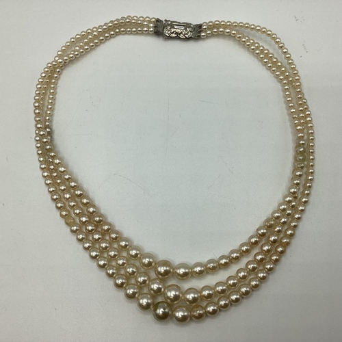 66 - A collection of costume jewellery to include faux pearl necklace and bracelet set, 6 bangle white me... 