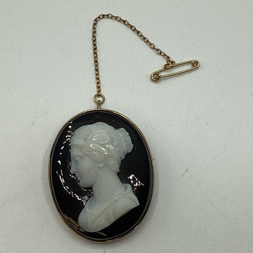 69 - A yellow metal hardstone oval cameo of a classical maiden with a safety chain 4cm x 3.4cm