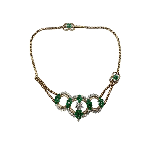 7 - An 18ct gold Emerald and diamond necklace. Retailed by Asprey's . Three articulated open work loops ... 