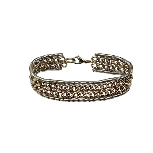 8 - A 9ct yellow and white gold flat belt link bracelet. Approx 17cm. 32g.