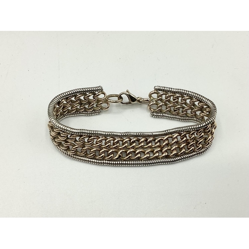 8 - A 9ct yellow and white gold flat belt link bracelet. Approx 17cm. 32g.