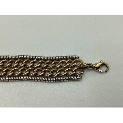 8 - A 9ct yellow and white gold flat belt link bracelet. Approx 17cm. 32g.