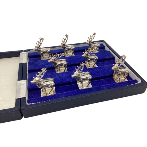 89 - A set of Sterling silver menu holders  of cast metal stags, by Camelot silver wear, Sheffield, 2004,... 