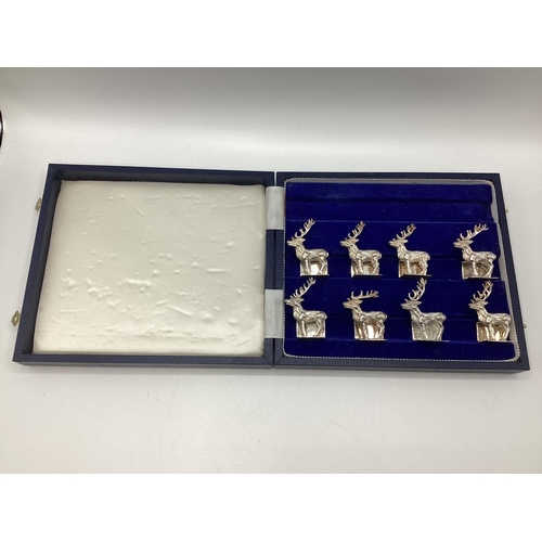 89 - A set of Sterling silver menu holders  of cast metal stags, by Camelot silver wear, Sheffield, 2004,... 