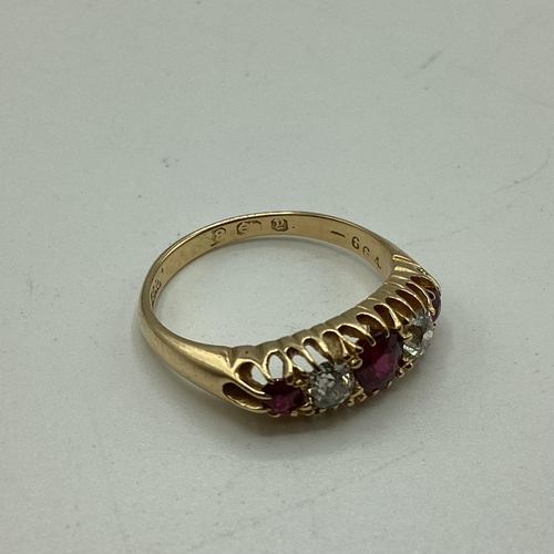 95 - An 18 carat gold Ruby and diamond ring, 3 round free cut rubies set with two old cut diamonds, 3g  s... 