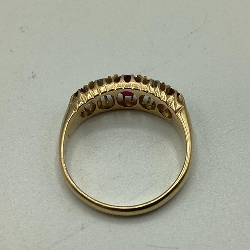 95 - An 18 carat gold Ruby and diamond ring, 3 round free cut rubies set with two old cut diamonds, 3g  s... 