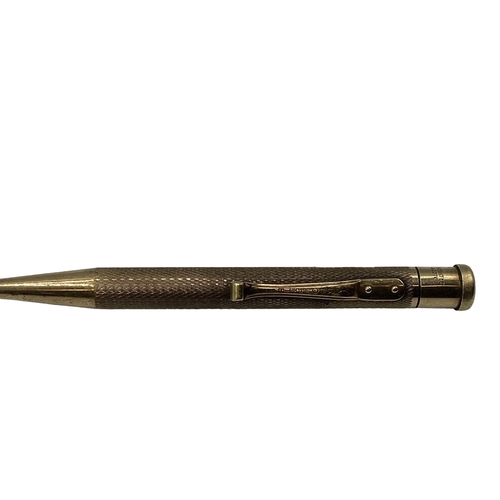 99 - A 9ct gold propelling pencil with engine turned decoration.