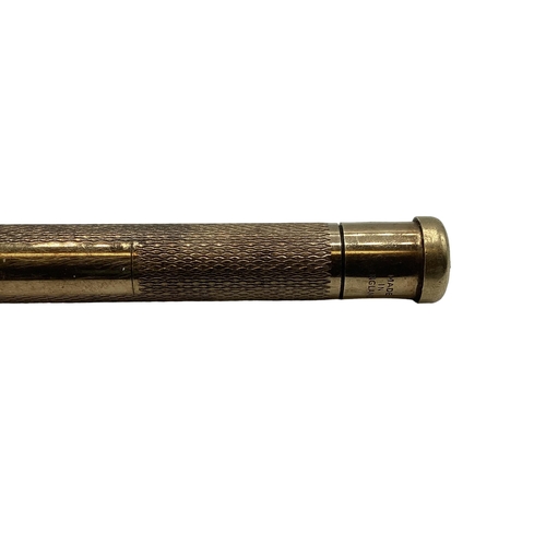 99 - A 9ct gold propelling pencil with engine turned decoration.