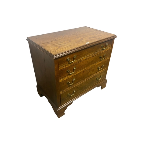 569 - A small oak chest of 4 graduated drawers, split to top, 72cmH x 48cmD x 78cmWide