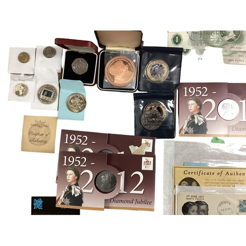 397 - A collection of 20th century commemorative and collectible coins and stamps and bank notes