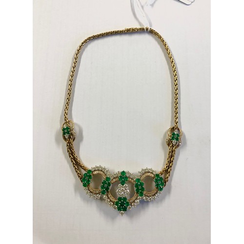 7 - An 18ct gold Emerald and diamond necklace. Retailed by Asprey's . Three articulated open work loops ... 