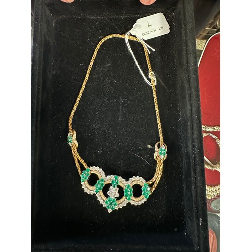 7 - An 18ct gold Emerald and diamond necklace. Retailed by Asprey's . Three articulated open work loops ... 