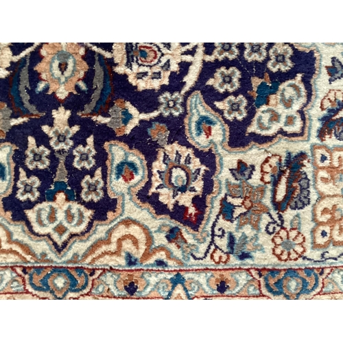 598 - A Persian wool rug,  blue and beige ground, with central star medallion, 114cm x 215cm, cleared from... 