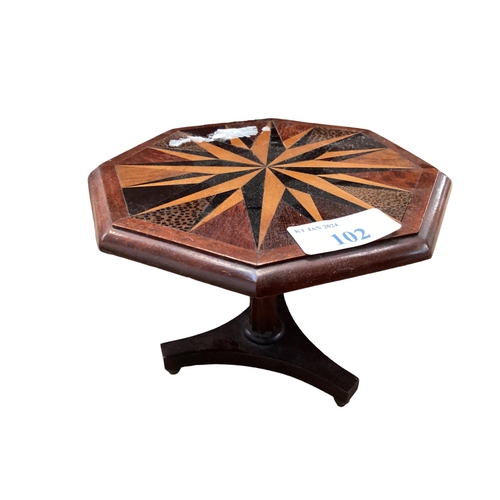 102 - Small wooden apprentice piece as a hexagonal table with starburst inlaid design and  a leather hut b... 