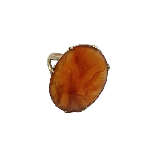 12 - An unmarked yellow metal carnelian set dress ring. 2.55g. Size P