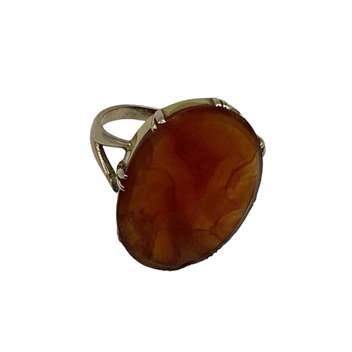 12 - An unmarked yellow metal carnelian set dress ring. 2.55g. Size P