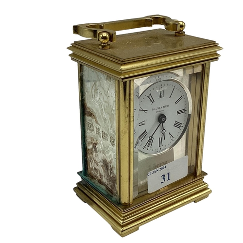 31 - A sterling silver panelled electric carriage clock. Gilt metal case with three sterling silver panel... 