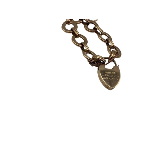 82 - A 9ct rose gold fancy link bracelet with heart locket. 7.10g.