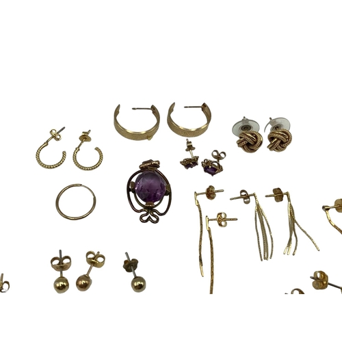 86 - A collection of 9ct gold and yellow metal earrings together with  an amethyst pendant and matching e... 