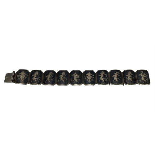 92 - A South East Asian white metal panel bracelet marked Siam.