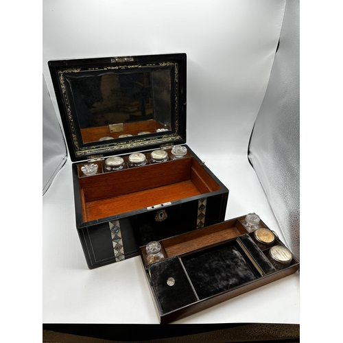 53 - An ebonised wooden and abalone and mother of pearl inlaid travelling case, opening to reveal mirrore... 