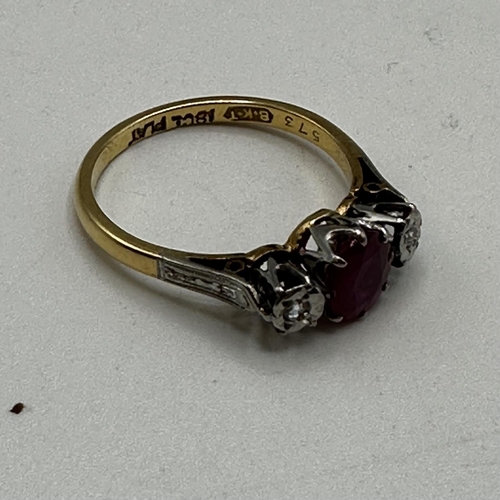 68 - An 18ct gold and platinum ring. Central oval free cut ruby with illusion set diamond accents. Size L... 