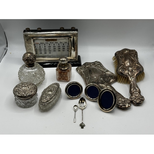 74 - A collection of sterling silver dressing table items. Desk calendar etc.