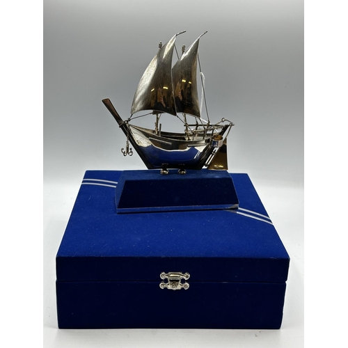 75 - A 925 silver model of a sailing ship in presentation box. 23cm x 18cm. On stand.