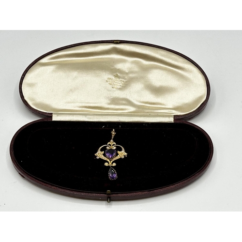 90 - A 15ct gold amethyst and split pearl art nouveau style pendant. 2.01g. In original box without chain... 