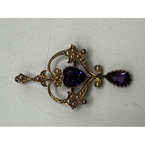 90 - A 15ct gold amethyst and split pearl art nouveau style pendant. 2.01g. In original box without chain... 