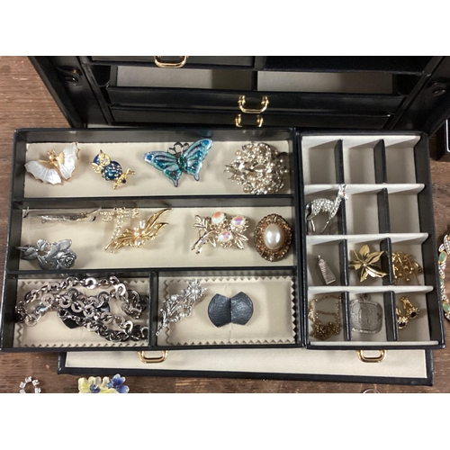 11 - Large collection of costume jewellery, contained within a good quality leather jewellery box