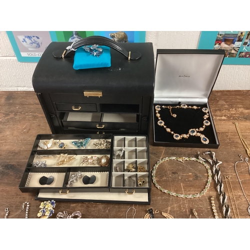 11 - Large collection of costume jewellery, contained within a good quality leather jewellery box