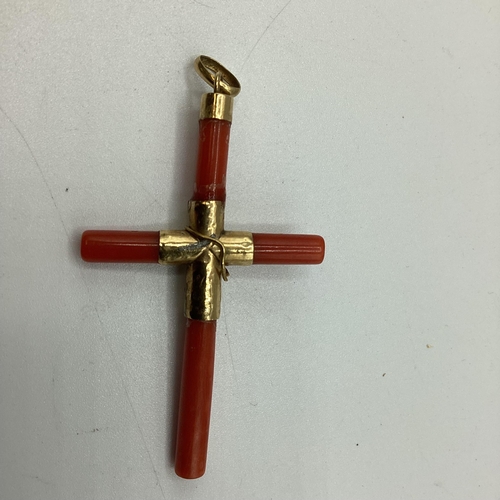 14 - A red coral and yellow metal crucifix pendant together with other coral and garnet bead necklaces, t... 