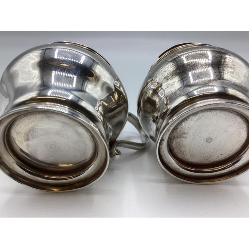 26 - A pair of sterling silver mustards of bulbous form on circular stepped foot by D&J Welby Ltd, London... 