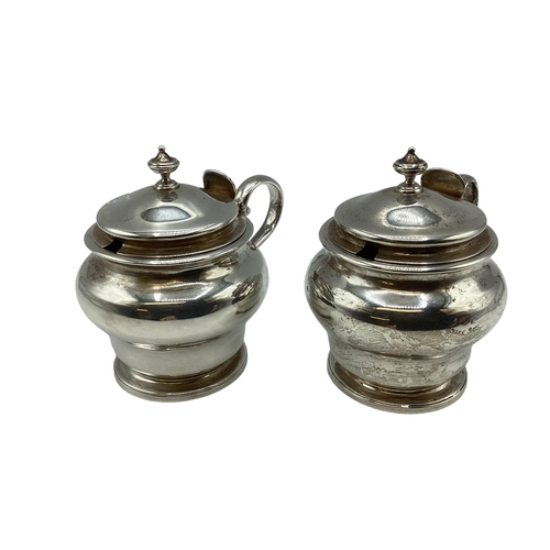 26 - A pair of sterling silver mustards of bulbous form on circular stepped foot by D&J Welby Ltd, London... 