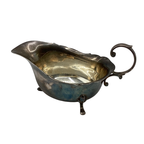 27 - A sterling silver sauceboat together with a sterling silver mini pepper grinder. William Suckling, B... 