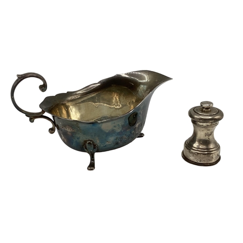 27 - A sterling silver sauceboat together with a sterling silver mini pepper grinder. William Suckling, B... 