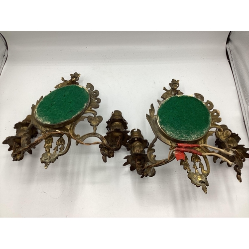 251 - A pair of early C20th wall sconces with oval mirrors and foliate decoration, approx 31cm High overal... 