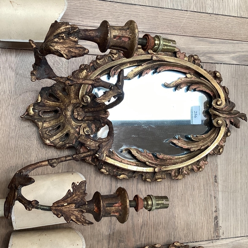 256 - A pair of oval sconces, with mirrored back and ornate floral carved gesso surround, 39cm High overal... 