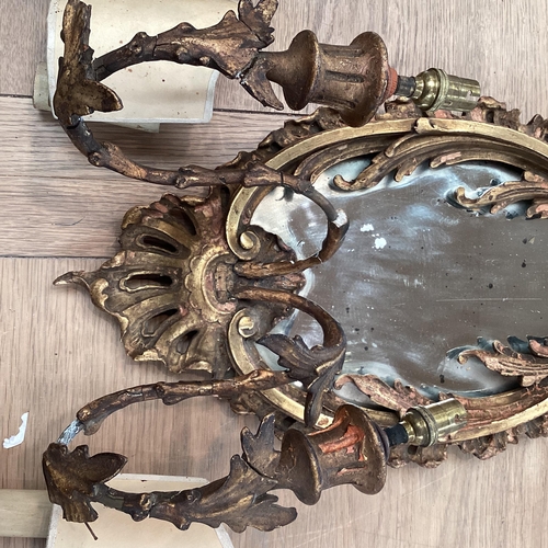 256 - A pair of oval sconces, with mirrored back and ornate floral carved gesso surround, 39cm High overal... 