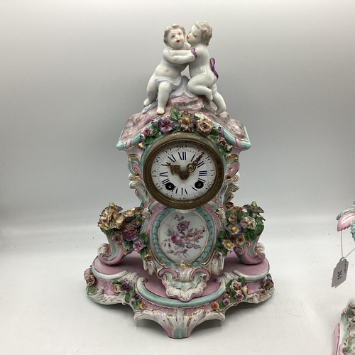 261 - A Meissen clock on stand, and a two branch candleholder, 22cmH,