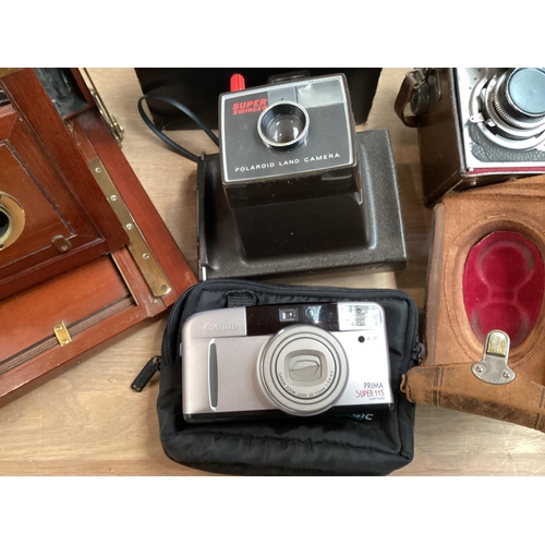 262 - A quantity of vintage cameras including a Marion & Co, 22 & 23 Soho Square, London W, see images