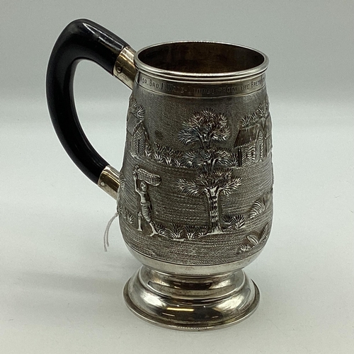 62 - A South Asian white metal mug with country scenes and elephants. Engraved from 'The Calcutta Lodge'.... 