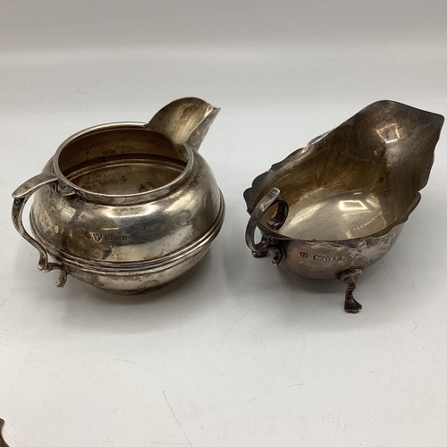 78 - Three sterling silver items, to include footed sugar bowl, cream jug and small sauce boat, various d... 