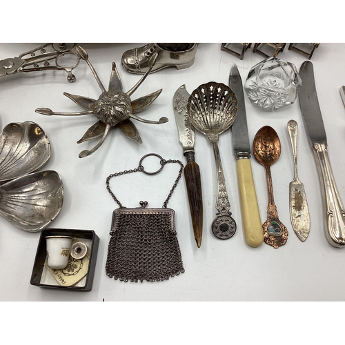 85 - A collection of unmarked white metal items to include wick scissors, dolls house furniture and other... 