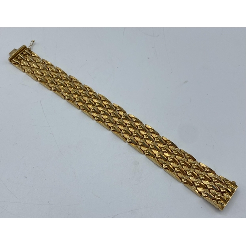 142 - An 18ct gold buckle bracelet, 49g