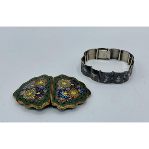 30 - A Japanese Cloisonné belt buckle, Meiji Period together with a Siam silver panel bracelet.