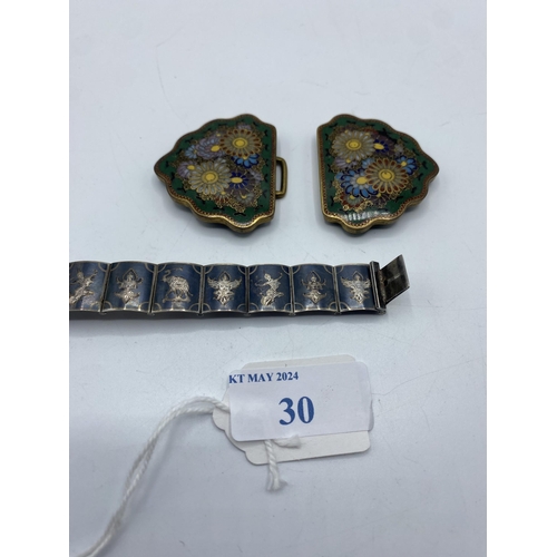 30 - A Japanese Cloisonné belt buckle, Meiji Period together with a Siam silver panel bracelet.