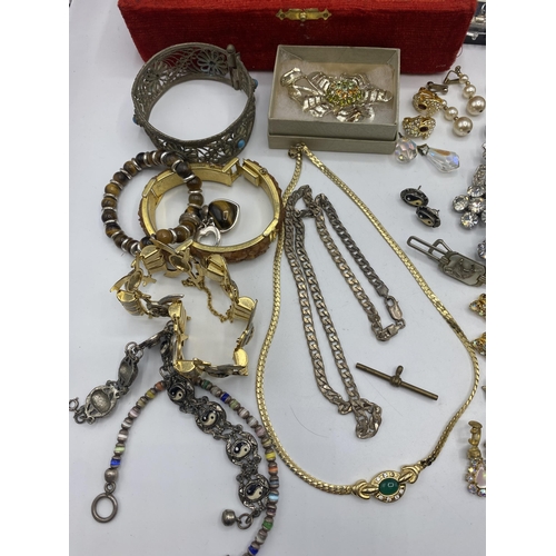 38 - A collection of silver, unmarked white metal and costume jewellery.